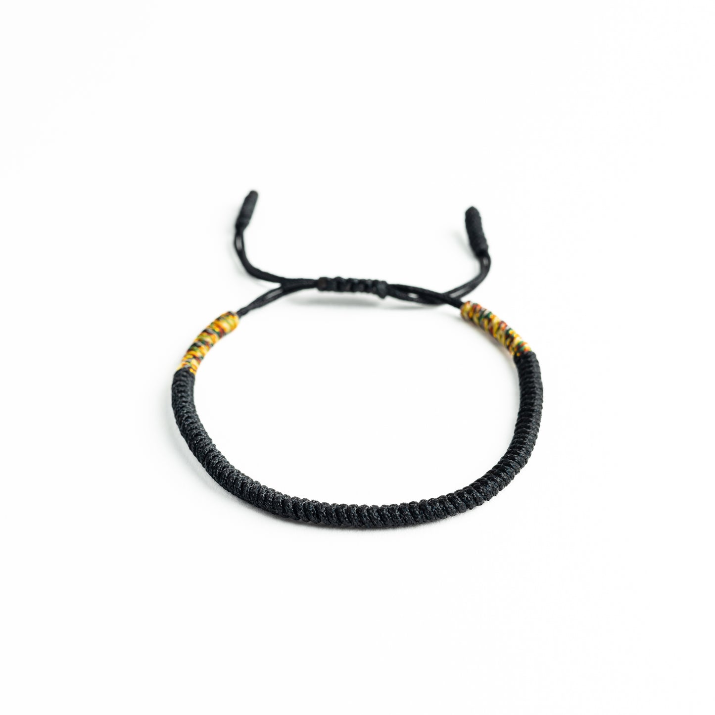 Midnight Mosaic: Black Bracelet with Multicolored Thread Accents