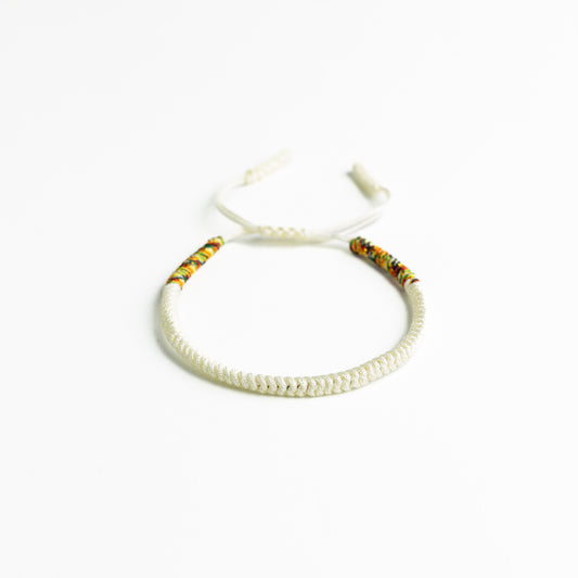 Pearl Kaleidoscope: Off-White Tibetan Bracelet with Multicolor Thread Accents