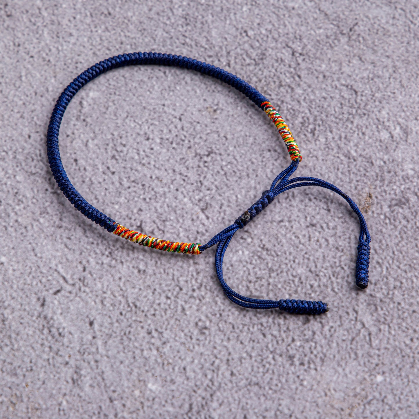 Midnight Kaleidoscope: Dark Blue Bracelet with Multicolor Thread Accents